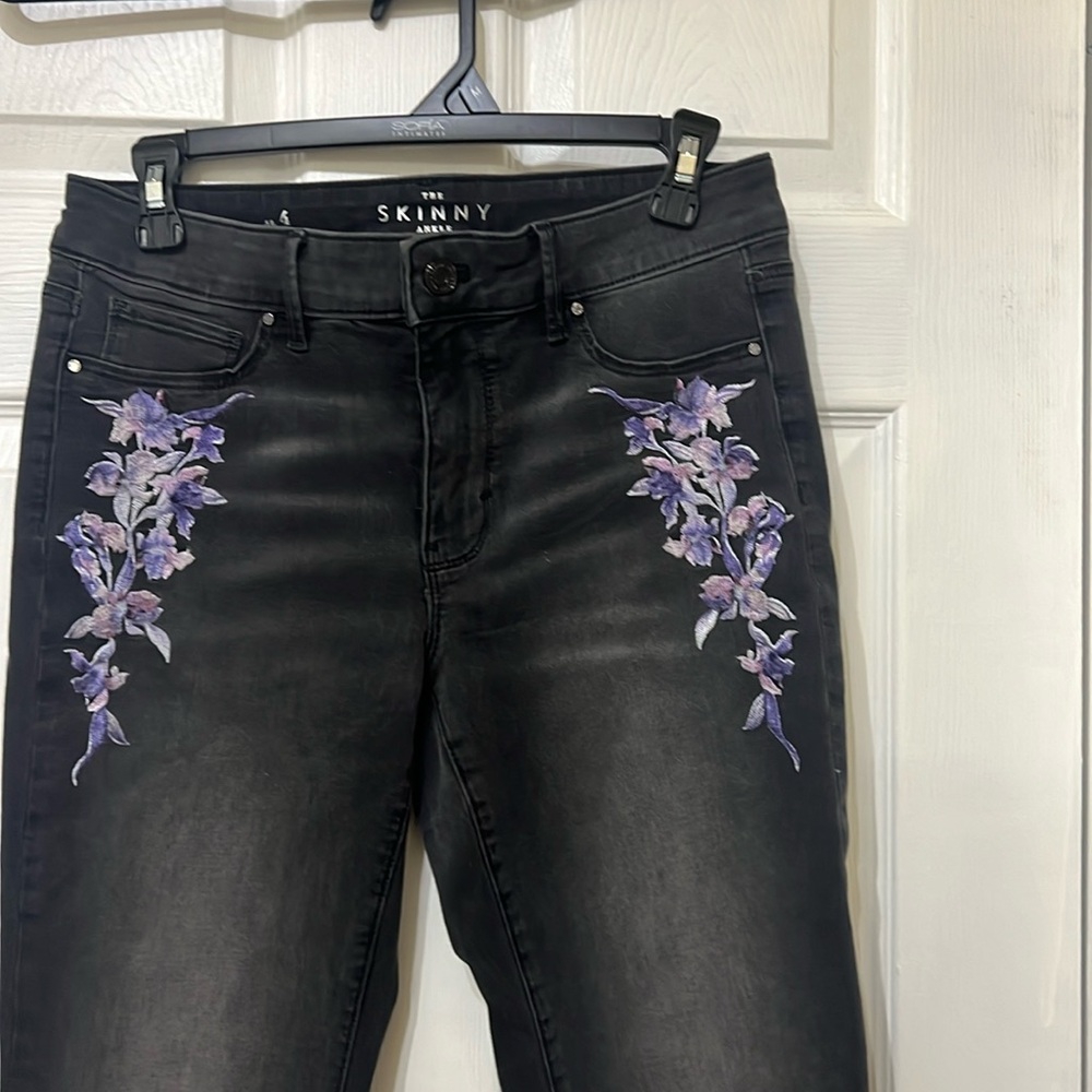 White House Black Market skinny jeans, size 4, with purple embroidering on it